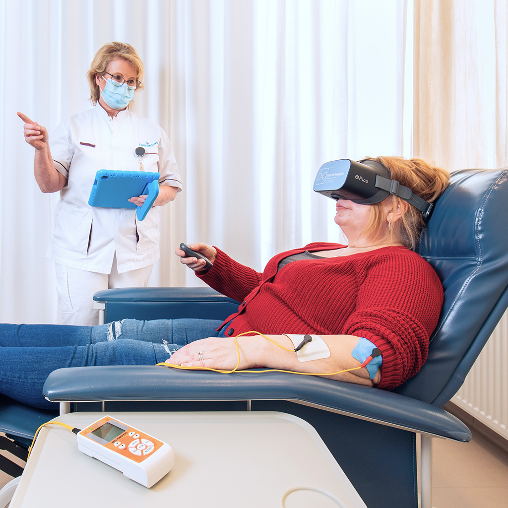 Patient using a VR headset during treatment to reduce pain, stress and medication